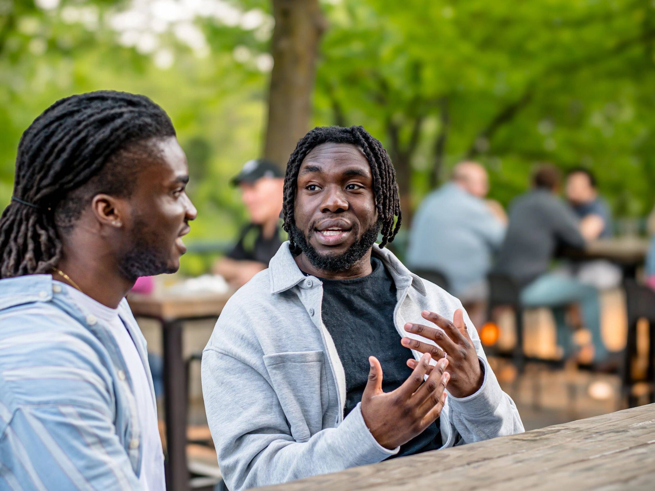 Lively Downtown Gathering: Young Black Men Chat in Bustling Downtown Winnipeg